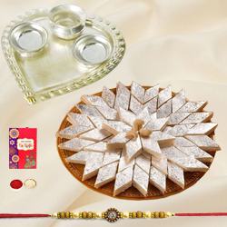 Delicious Kaju Katli and Stylish and Trendy looking Silver Plated Paan Shaped Puja Aarti Thali along Rakhi, Roli, Tilak and Chawal