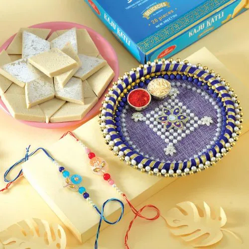 Fantastic Set of 2 Rakhis, Kaju Katli N Puja Thali with Message Card