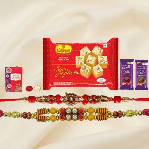 Exquisite Festive Favorite Sweets N Chocolate Gift Hamper with Two Rakhis With Free Rakhi Card and Roli Tilak Chawal