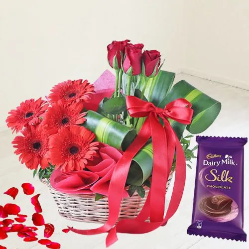 Appealing Basket of Red Flowers with Cadbury Chocolates