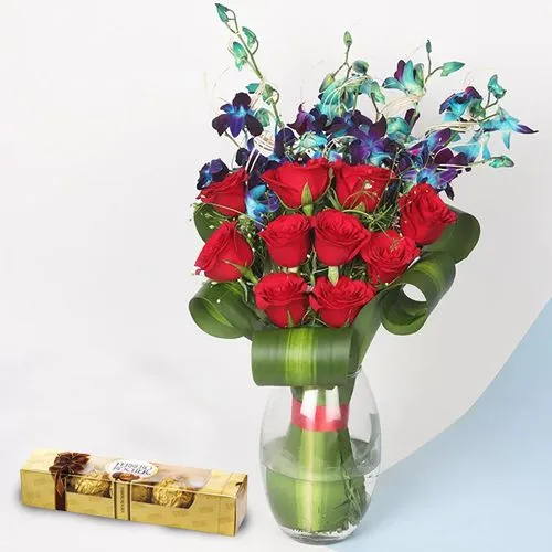 Enigmatic Red Roses n Blue Orchids in a Glass Vase with Ferrero Rocher Chocolates