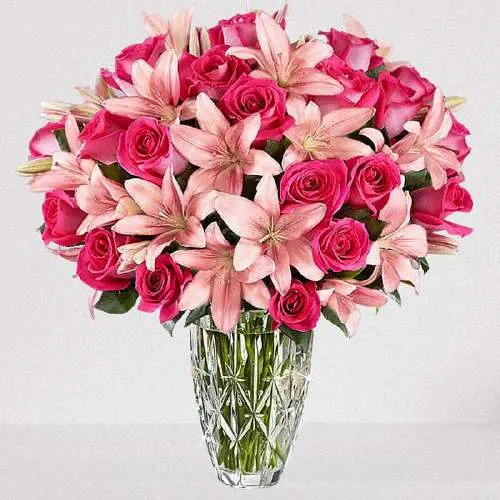 Clad in Pink Vase of Roses n Lilies