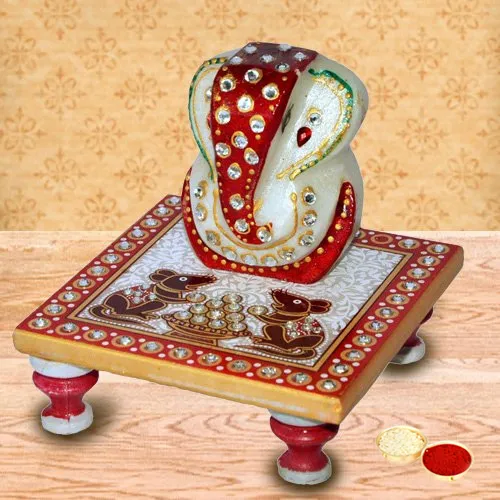 Delicately carved marbel designer ganesh with chowki with free Roli Tilak and Chawal