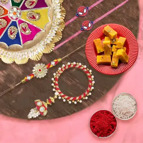 Charming Gift of Mysore Pak, 1 Bhaiya Bhabhi Rakhi, 2 Kids Rakhi and 1 Rakhi Thali