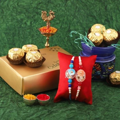 Delectable 12 pc Ferrero Rocher Pack with 2 Rakhis