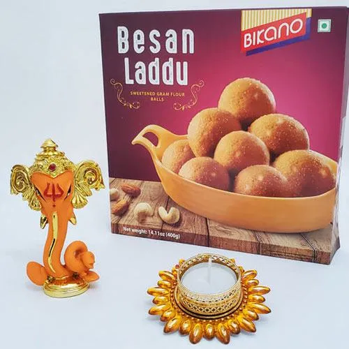 Admirable Gift of Besan Laddoo with Ganesha Idol N Candle